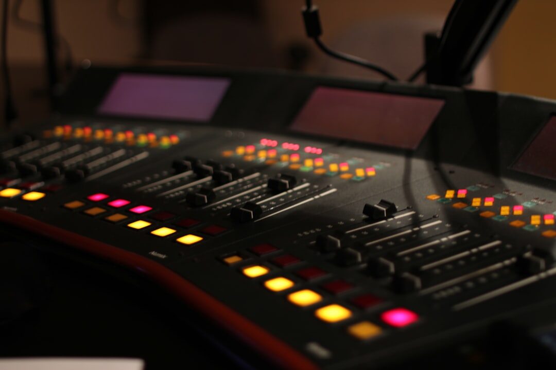Microphone in a professional radio studio with glowing equipment