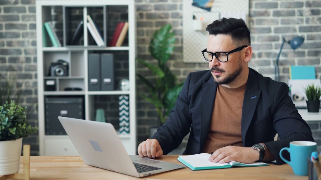 journalist at desk with laptop